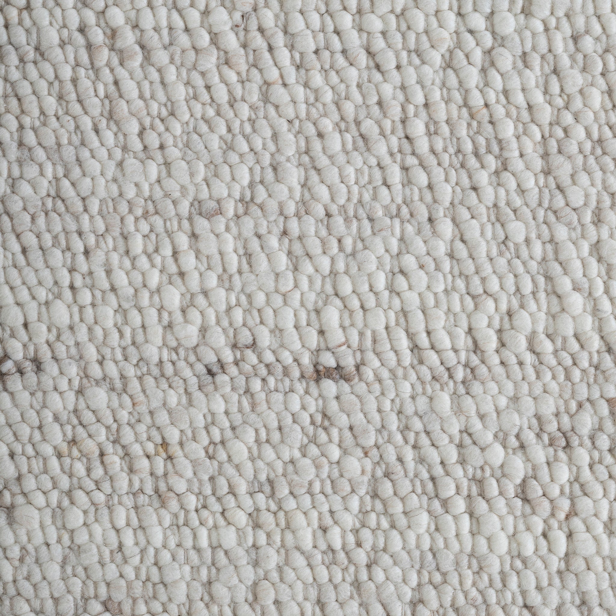 Close-up of Meghan rug texture, featuring a soft, plush surface in light beige tones.