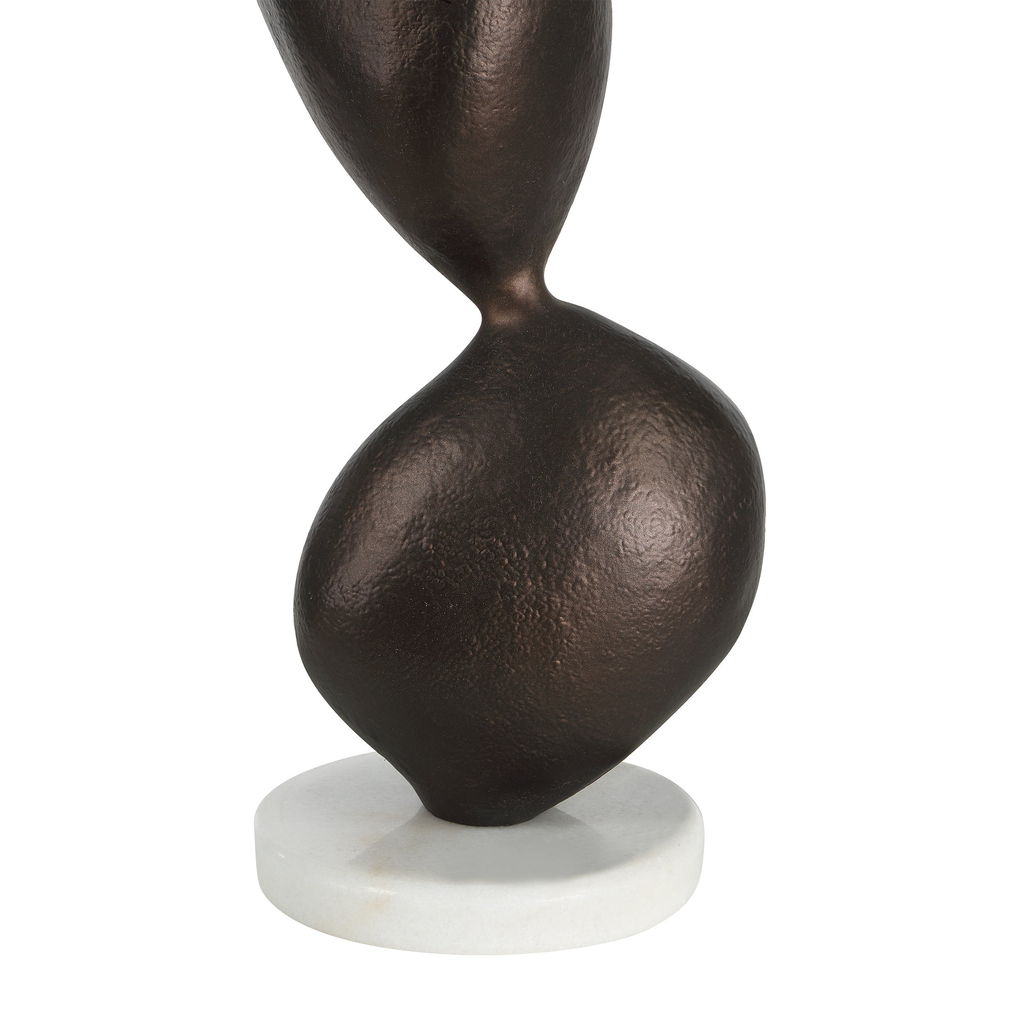 Close-up of Elle table lamp's brown sculptural base and white circular base.