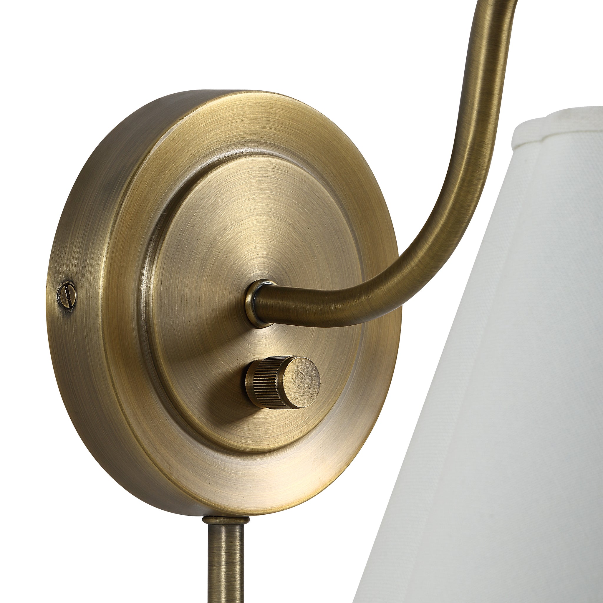 Close-up of Arielle wall sconce's brass mount and switch, highlighting its design.