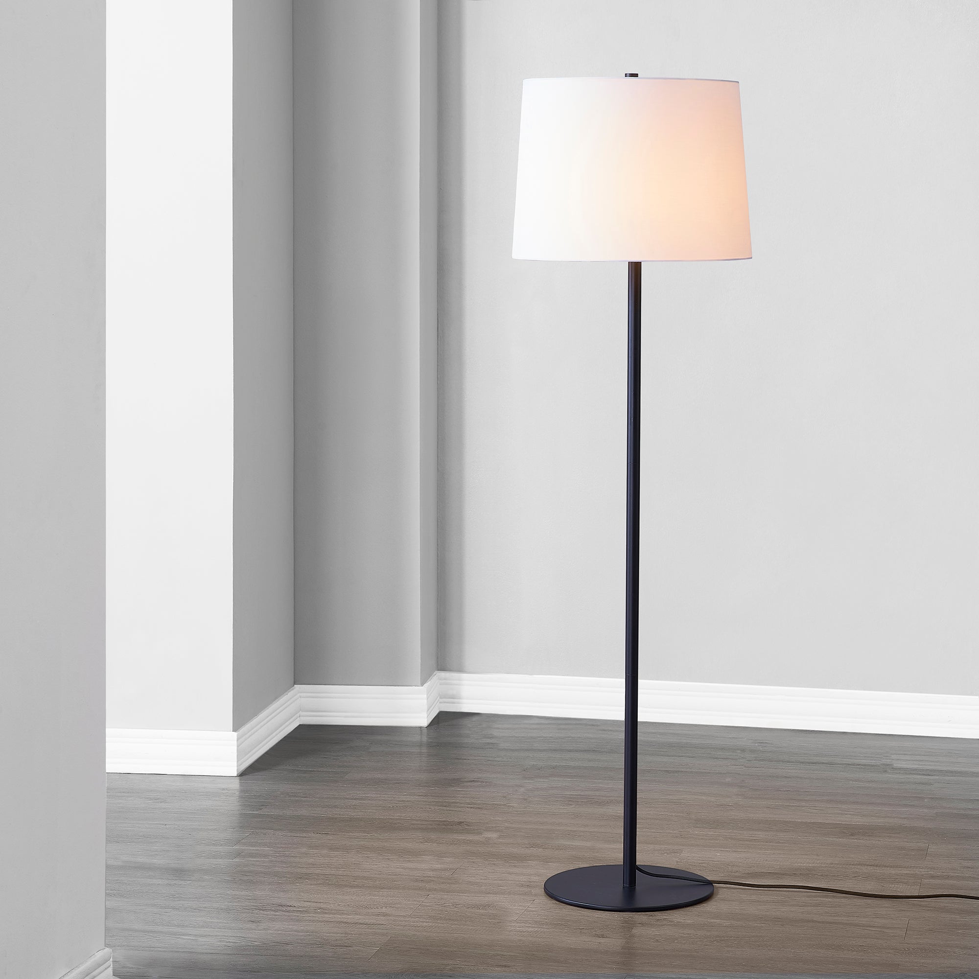 Nevin Floor Lamp illuminated, positioned in a contemporary space.