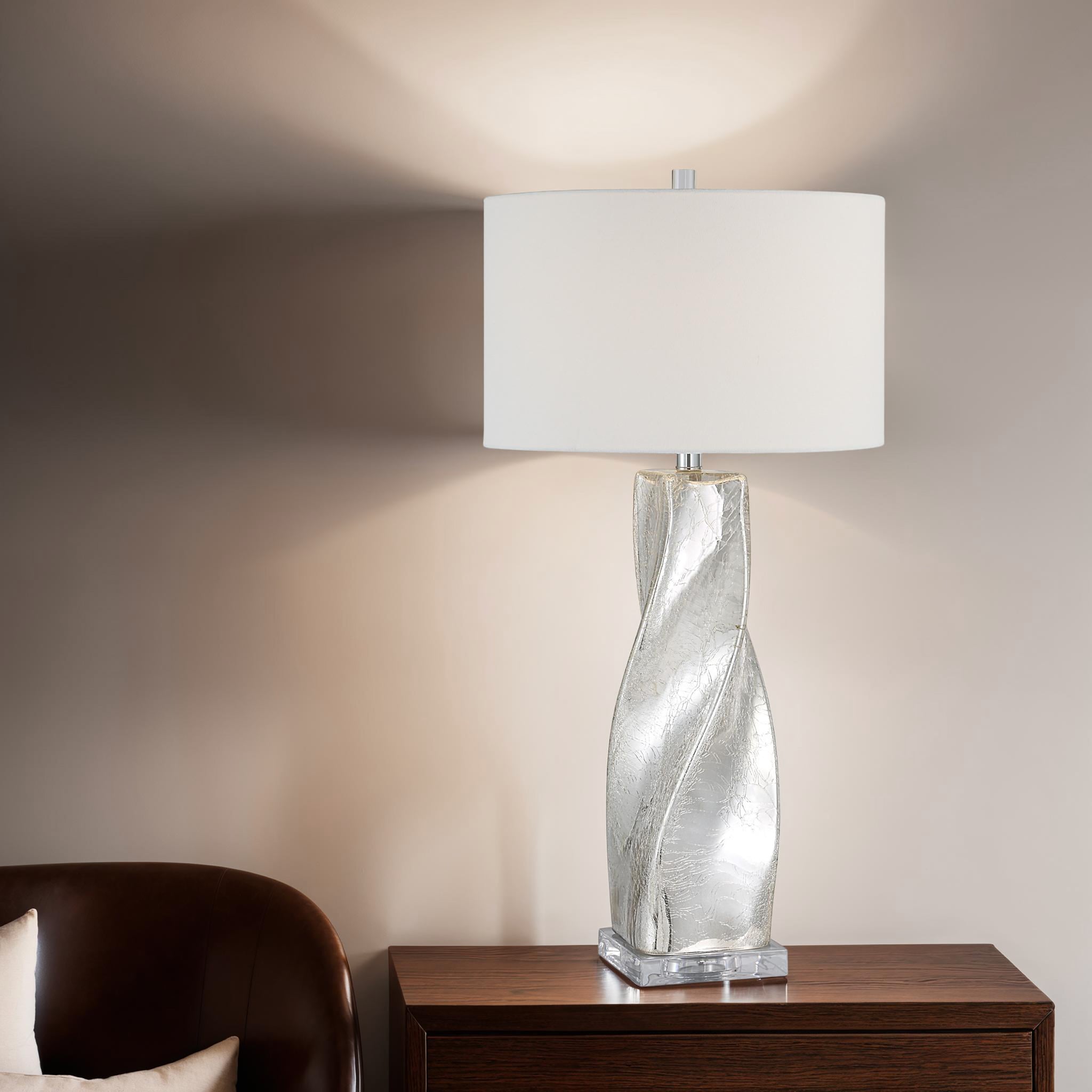 Lyons table lamp on a wooden table, casting light against a wall