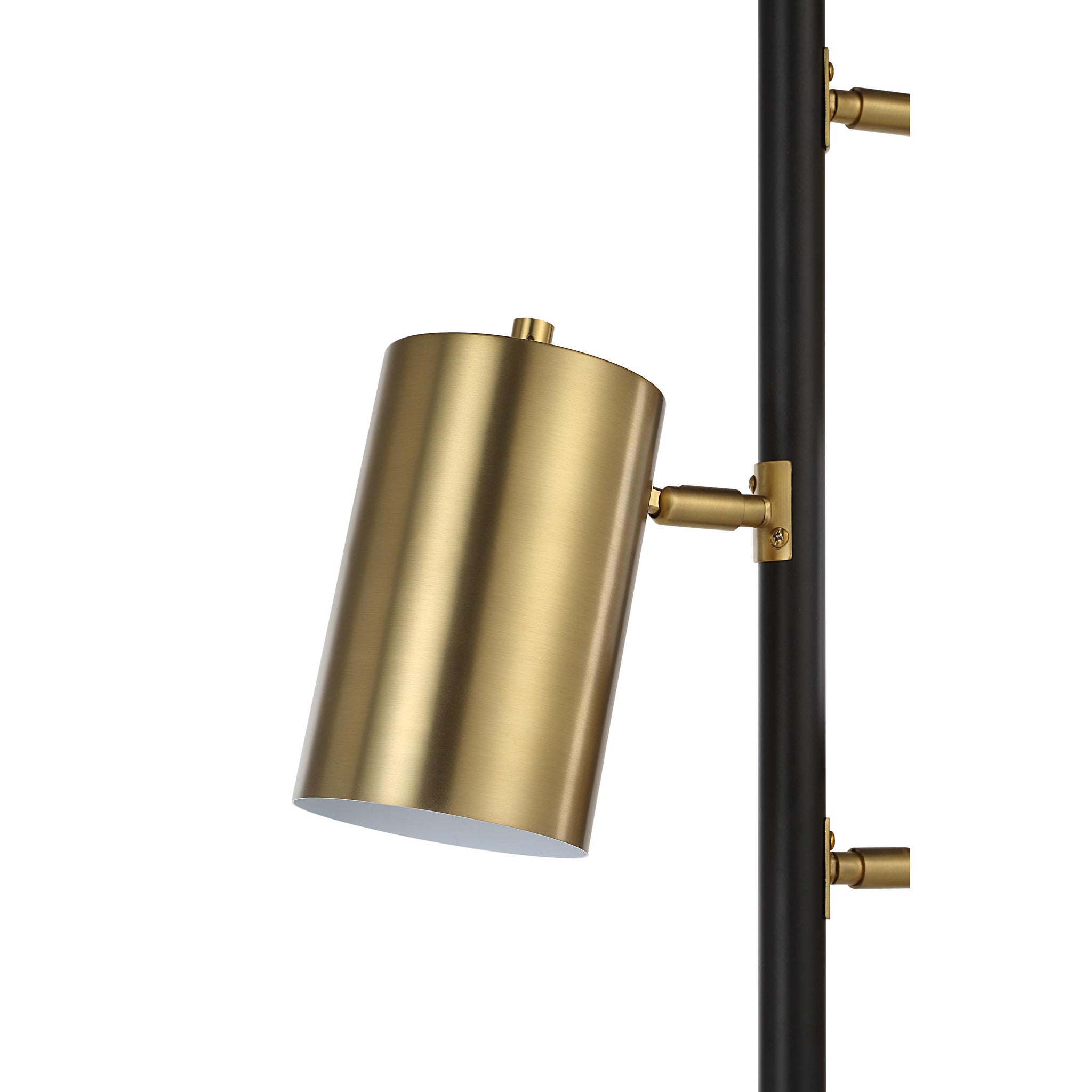 Close-up of a gold metal shade on the Mosaic floor lamp, attached to a black pole.