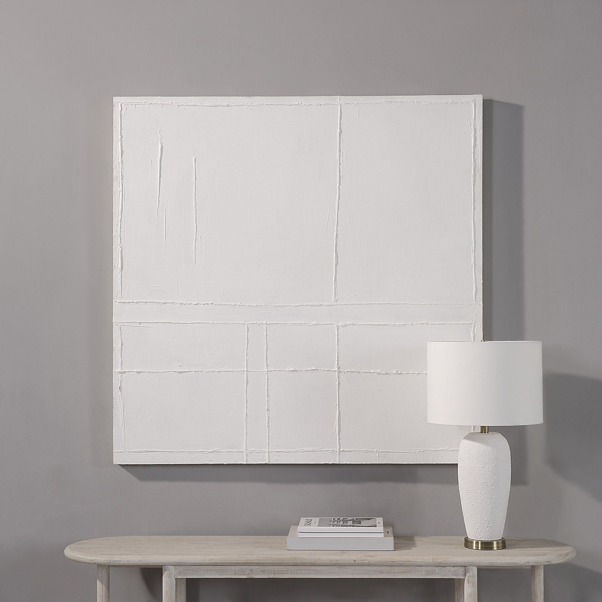 Medea Wall Art by Renwil displayed on a wall above a table with a lamp and books