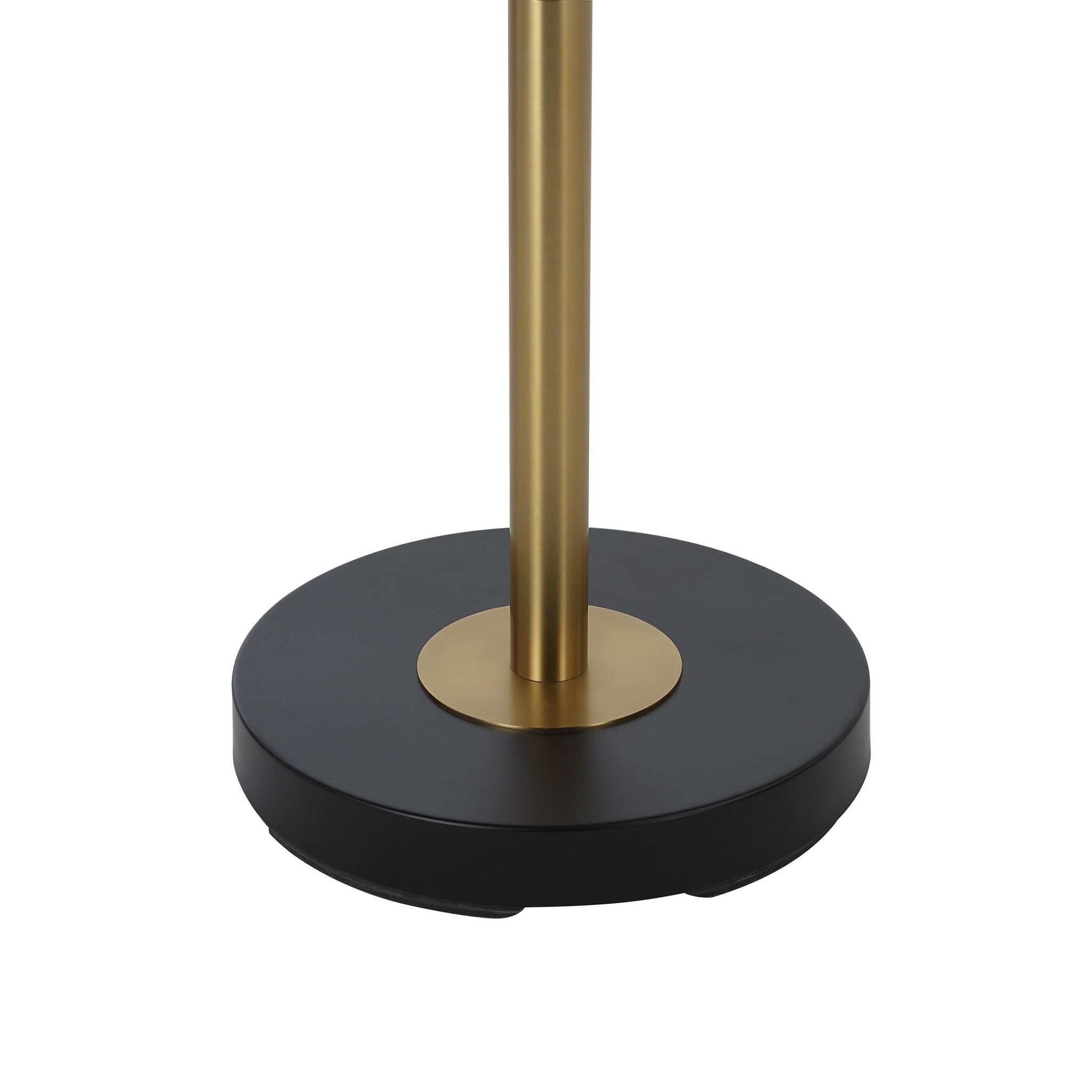 Close-up of Meander floor lamp's round black base with a gold center accent.