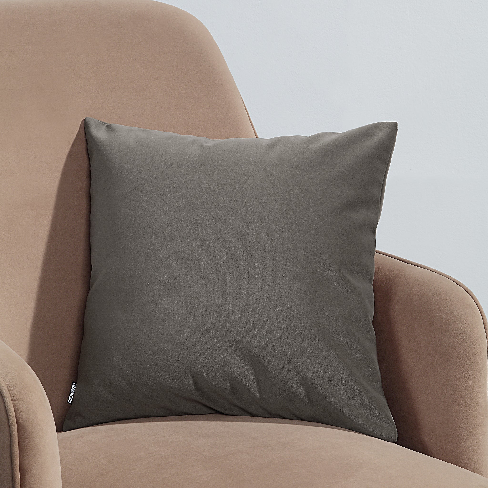 Antwerp Indoor Pillow in dark gray on a beige chair, square shape, side view.