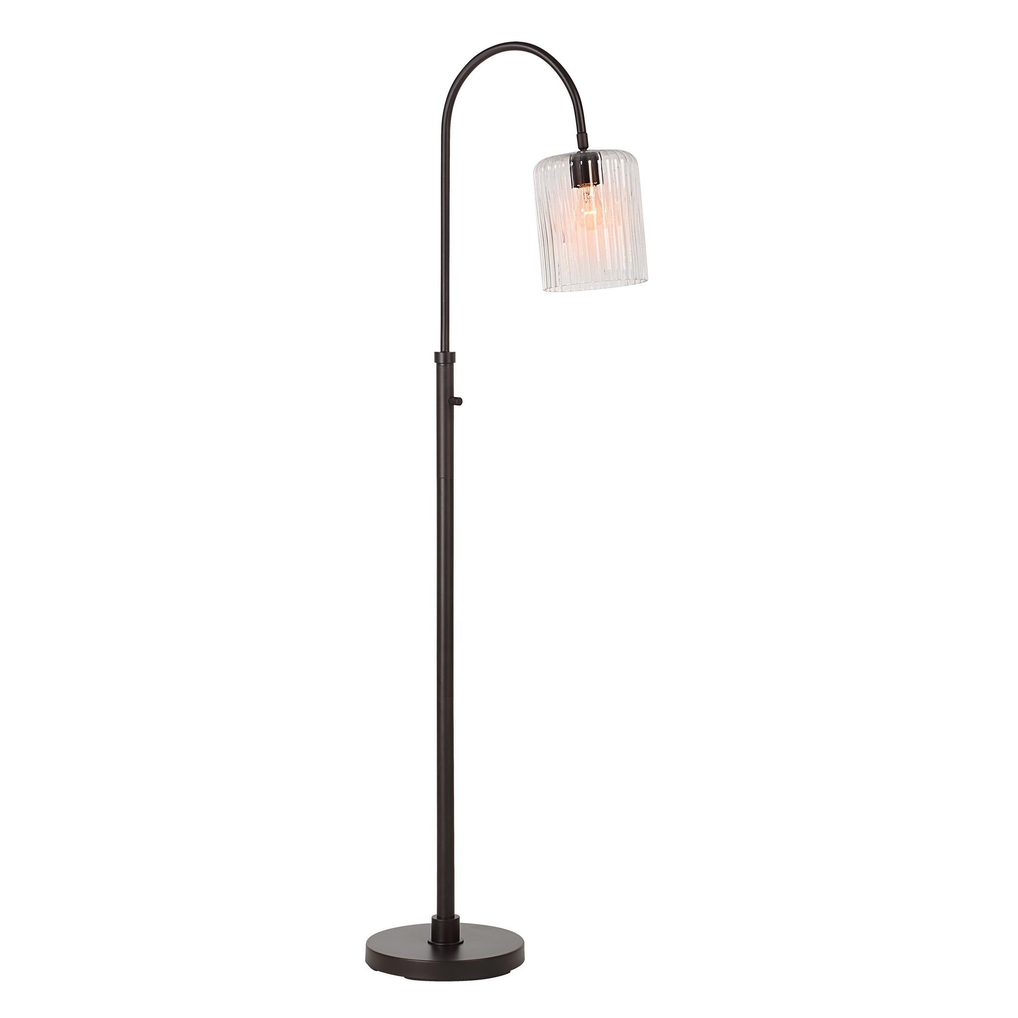 Danae floor lamp with a curved black metal stand and a clear ribbed glass shade, showcasing a warm light.