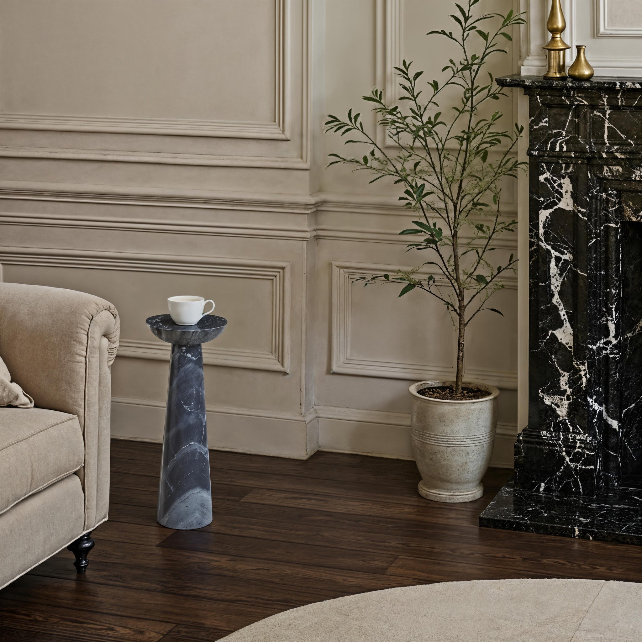Mercura side table in a classic interior, holding a coffee cup near a decorative plant.
