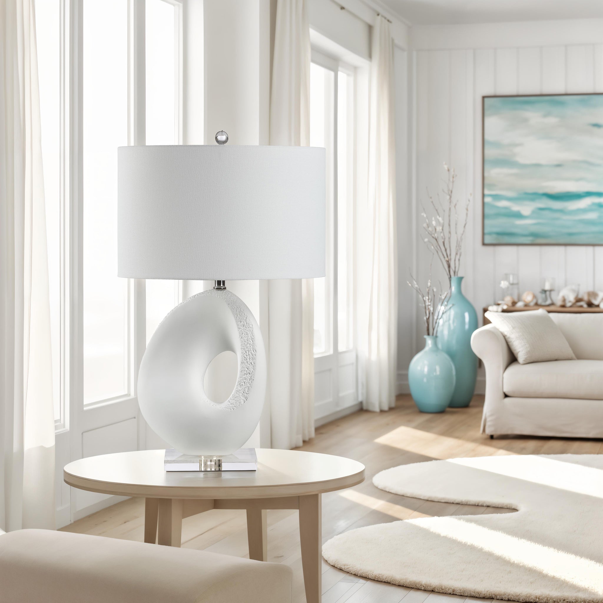 Opalis Table Lamp placed on a table in a bright living room setting.