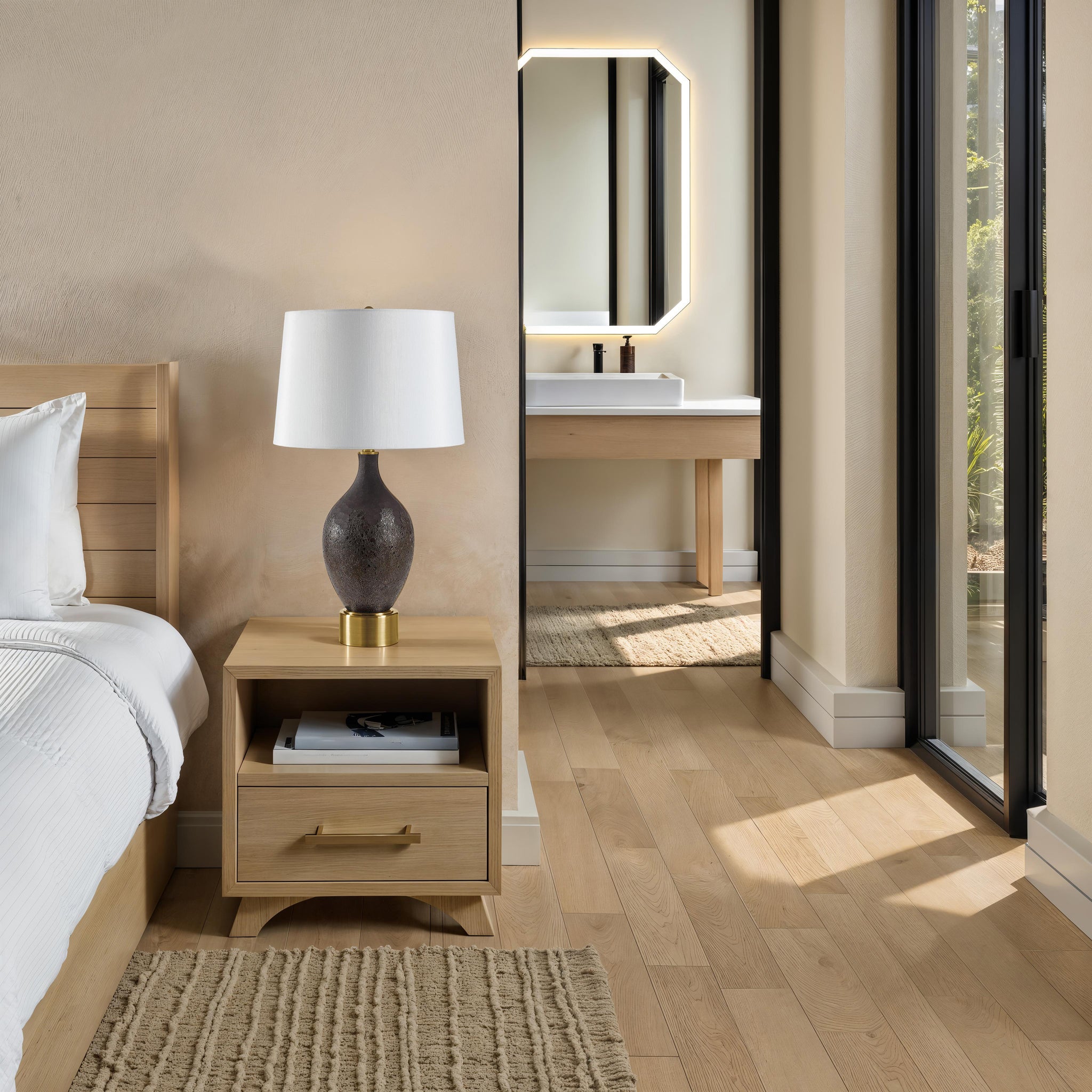 Weldon table lamp beside a bed in a modern room with a view of a bathroom