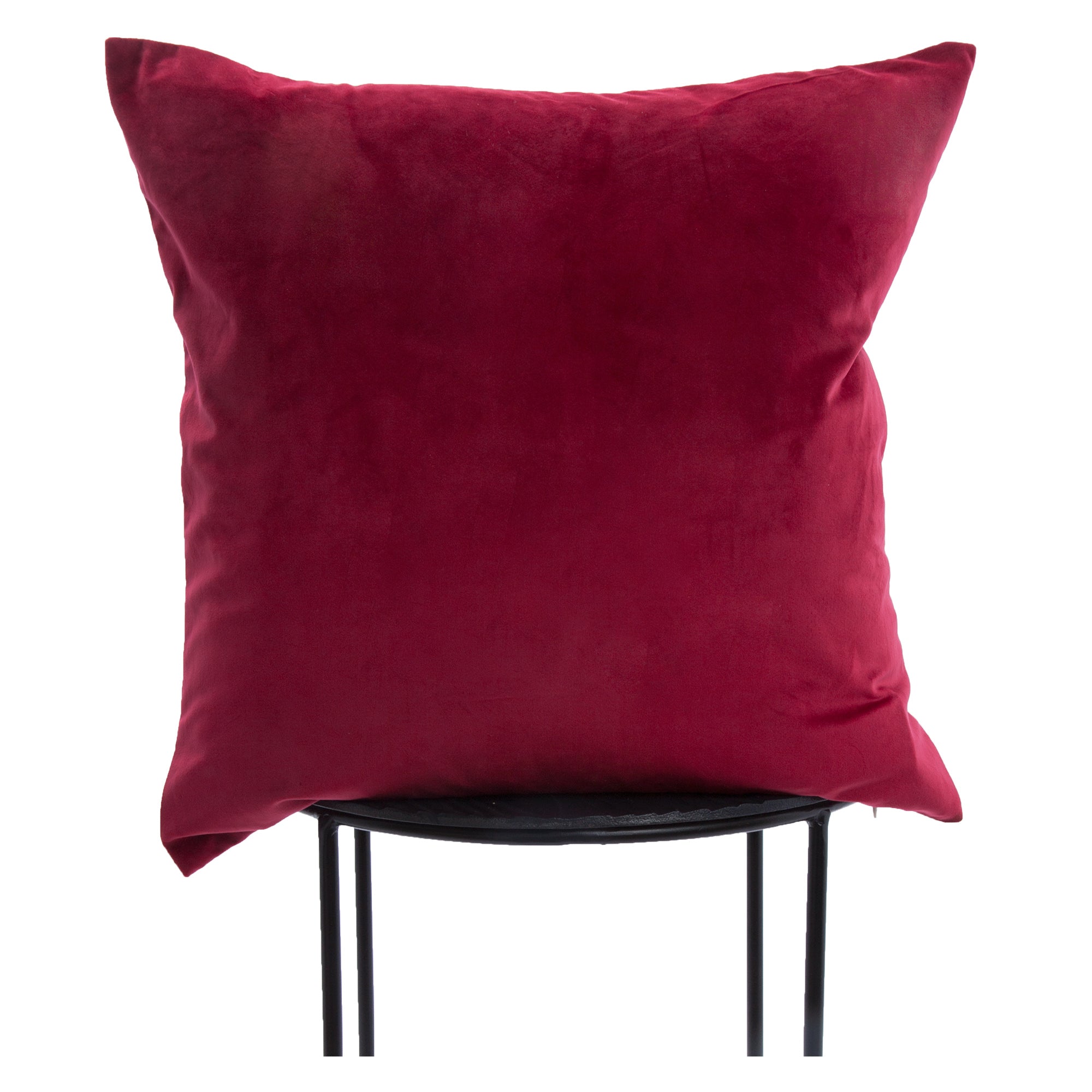 Cora Indoor Pillow in deep red velvet, displayed on a black metal stand.