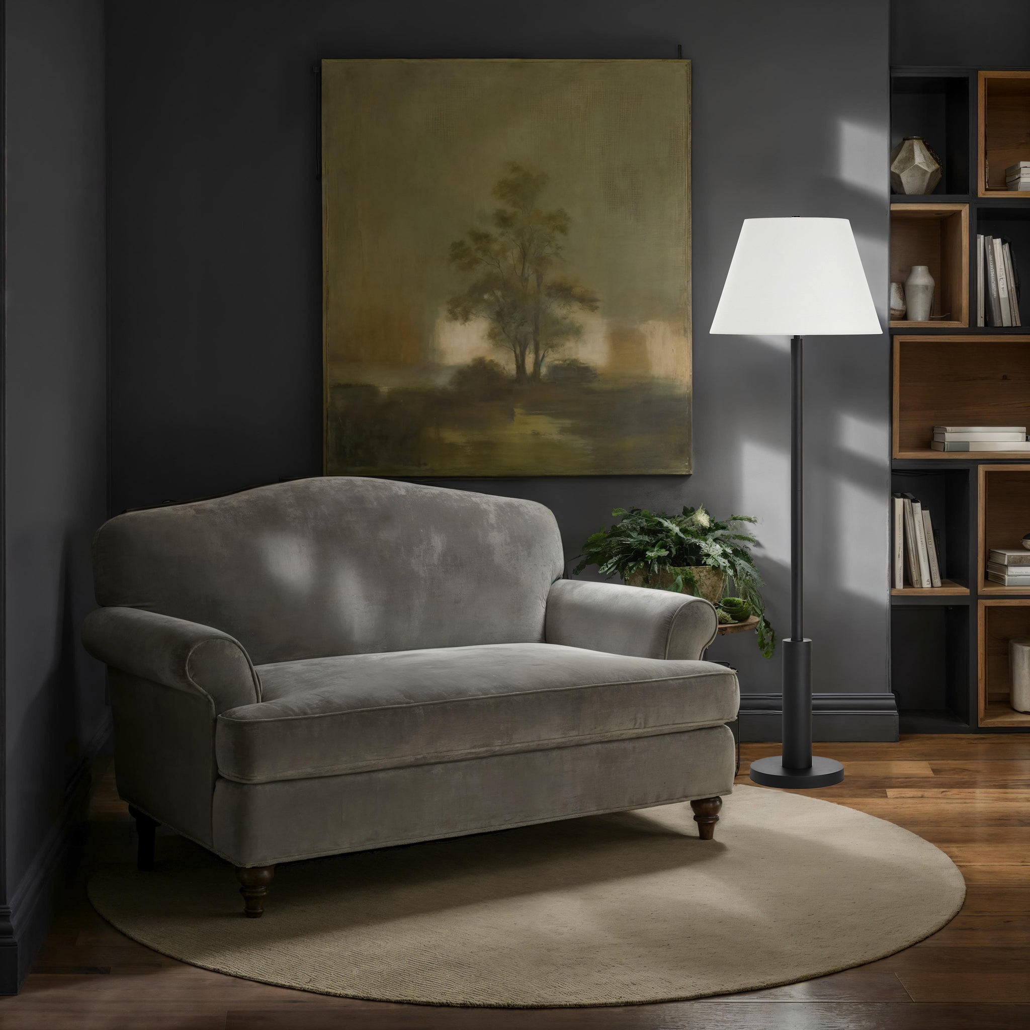 Pantera Floor Lamp by Renwil beside a gray sofa in a stylish living room.