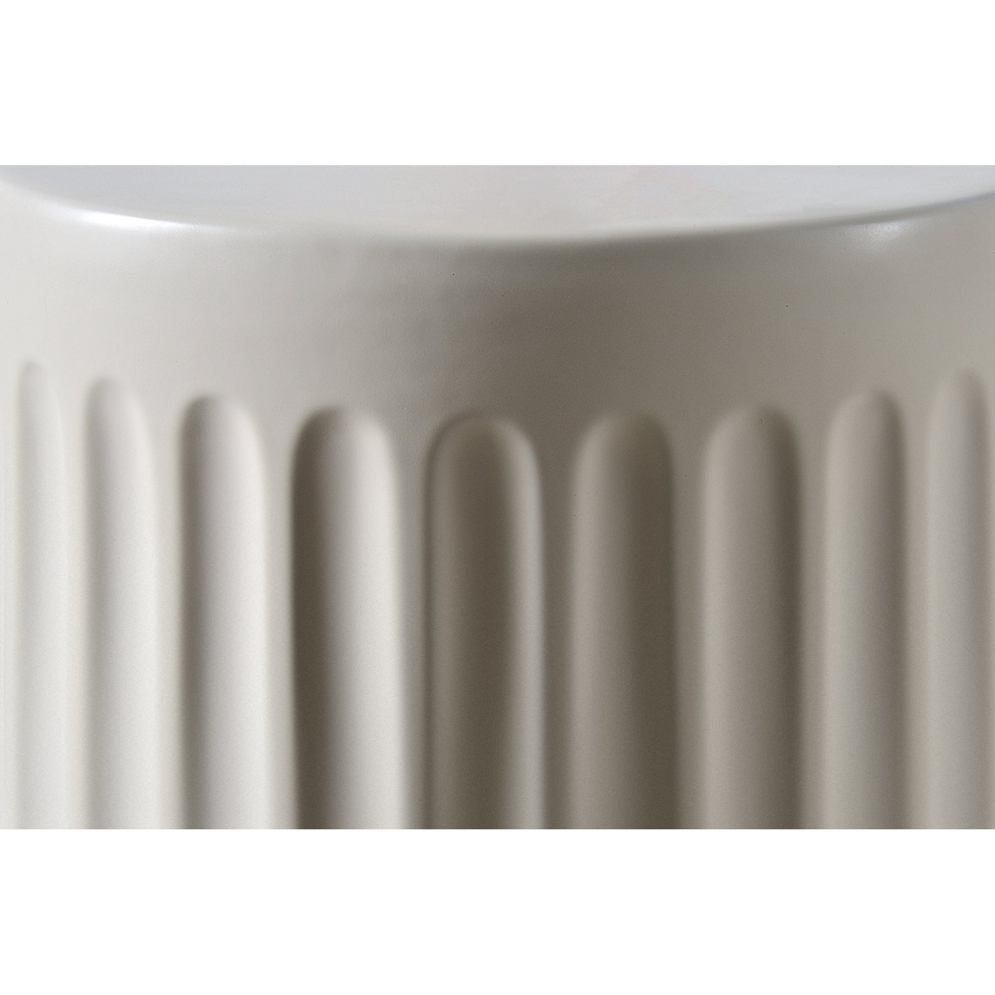 Lucian Table close-up showing light gray ceramic with ribbed detailing.