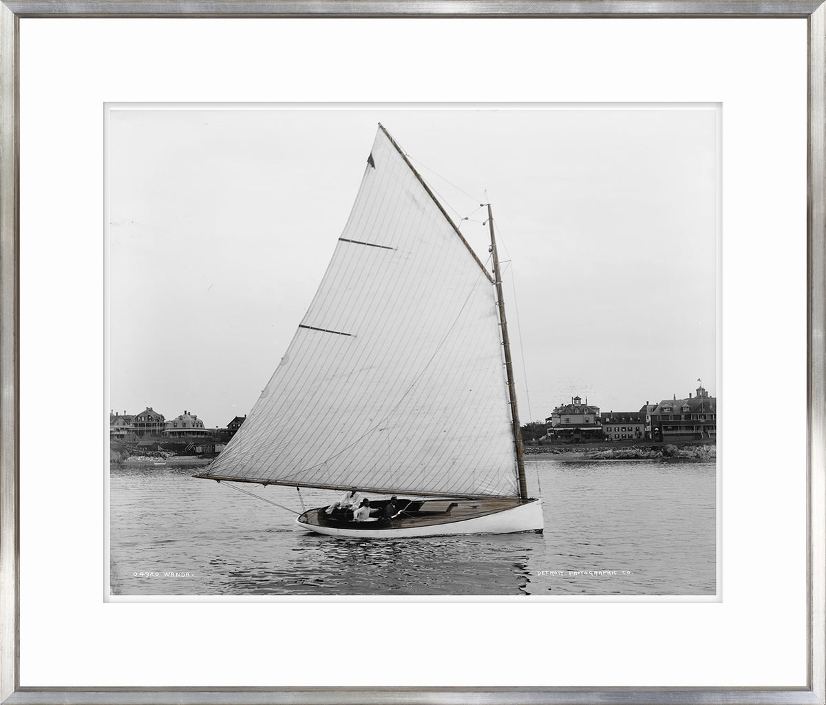 Wanda wall art featuring a black and white photograph of a sailboat on water.