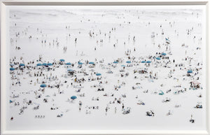 Teal Umbrellas wall art featuring a beach scene with numerous teal umbrellas and people on a white sandy beach.
