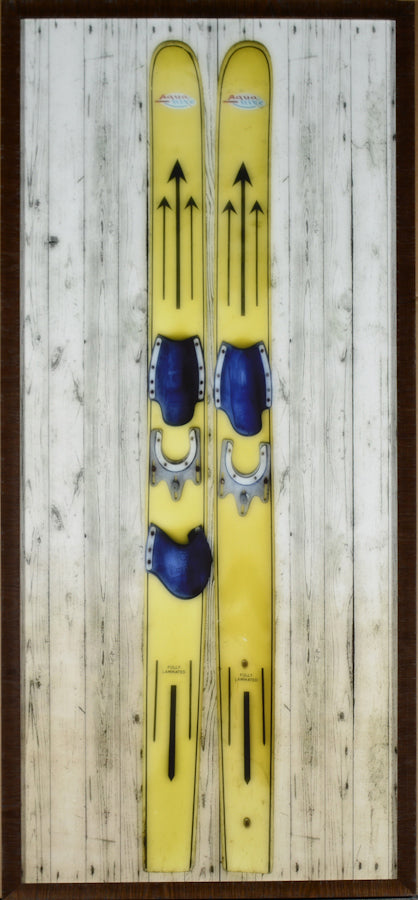 Vintage Water Skis wall art featuring yellow skis with blue bindings on a wood background.