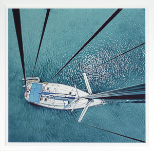 From The Birds Nest wall art featuring a sailboat viewed from above on turquoise water.