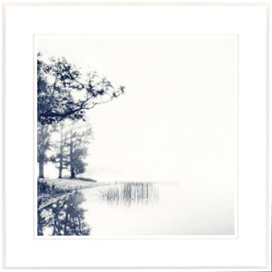 Indigo Landscape Series III wall art featuring a serene lake scene with trees and fog in blue tones.