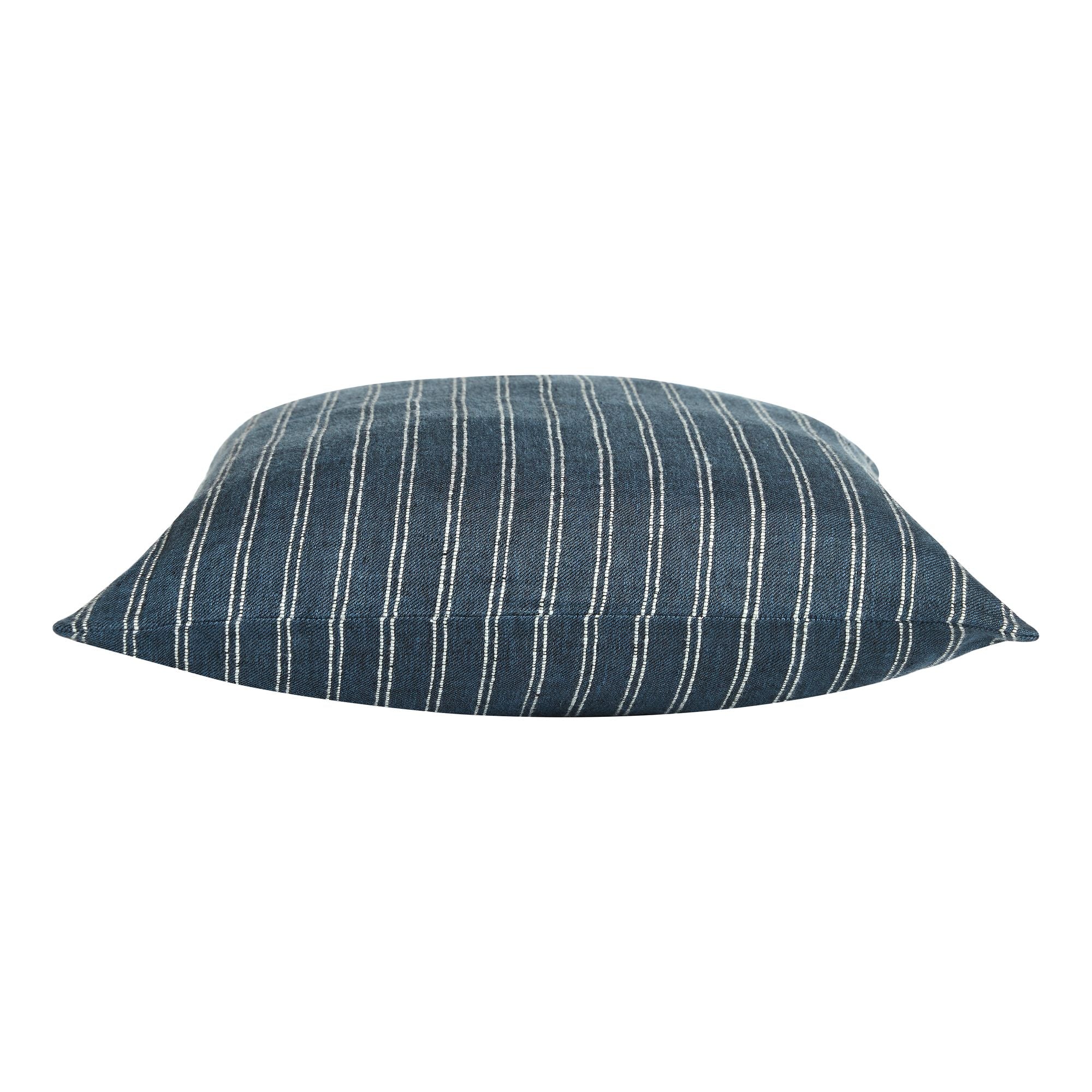 Oakley pillow featuring a dark blue fabric with white vertical stripes, showcasing a soft, rounded design.