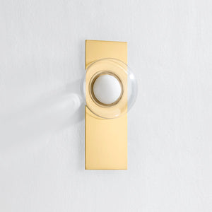 Pound Ridge Wall Sconce in aged brass shown from the front to reveal the arm curve and shade silhouette.