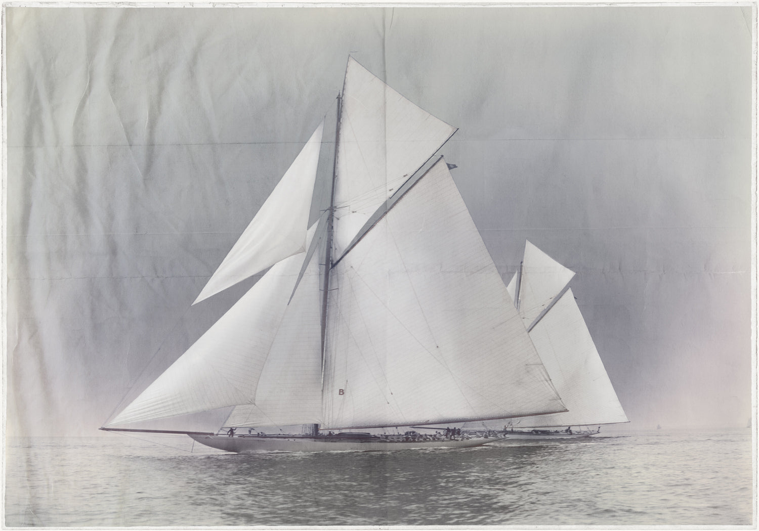 Indigo Stained – Yachts Constitution & Columbia, featuring a vintage sailboat with large white sails on calm waters.
