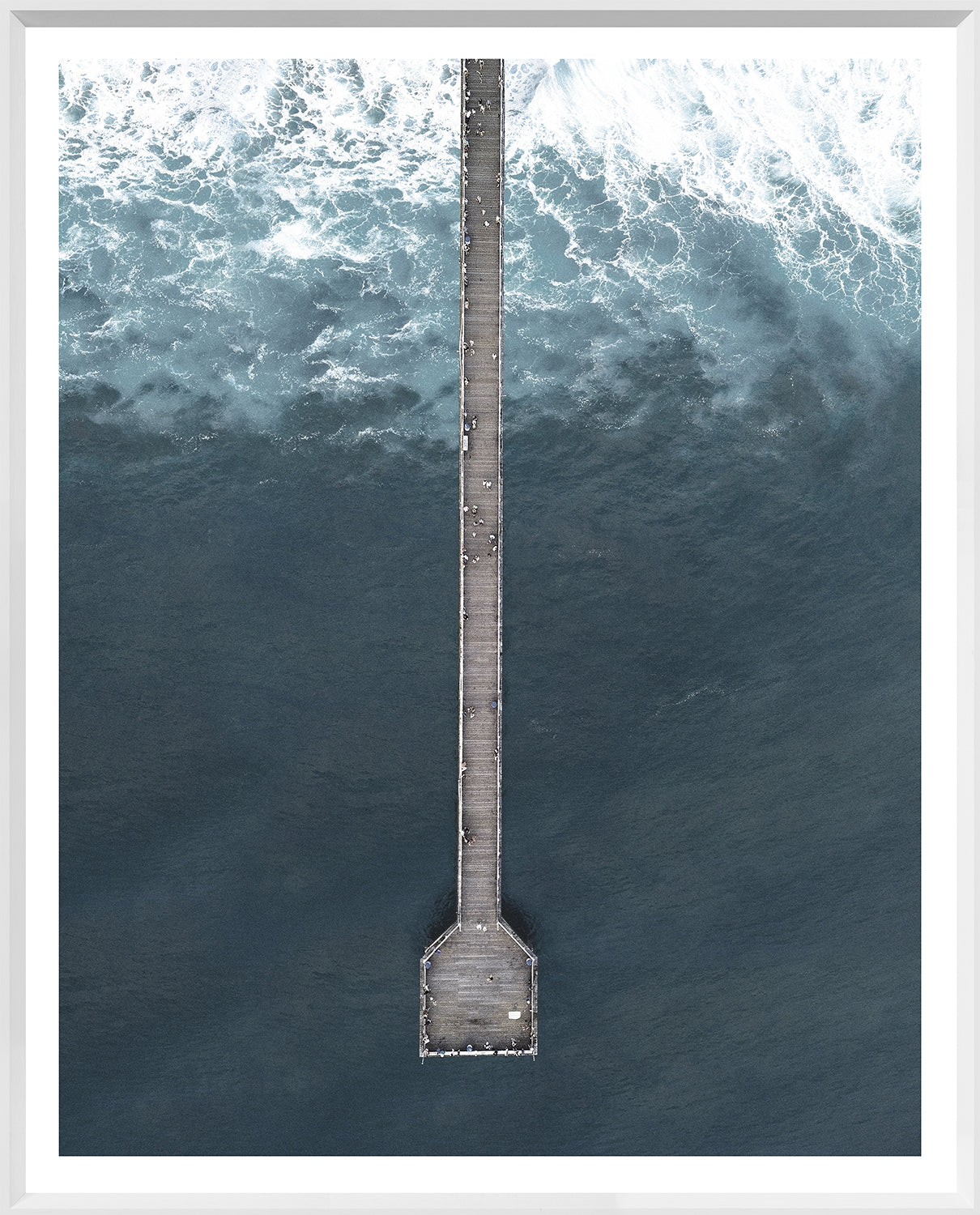 Deep Blue Wharf wall art featuring an aerial view of a pier over dark blue ocean waves