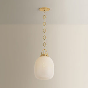Close-up of the Enosburg Pendant 11" in aged brass showing the shade shape and metal detail.
