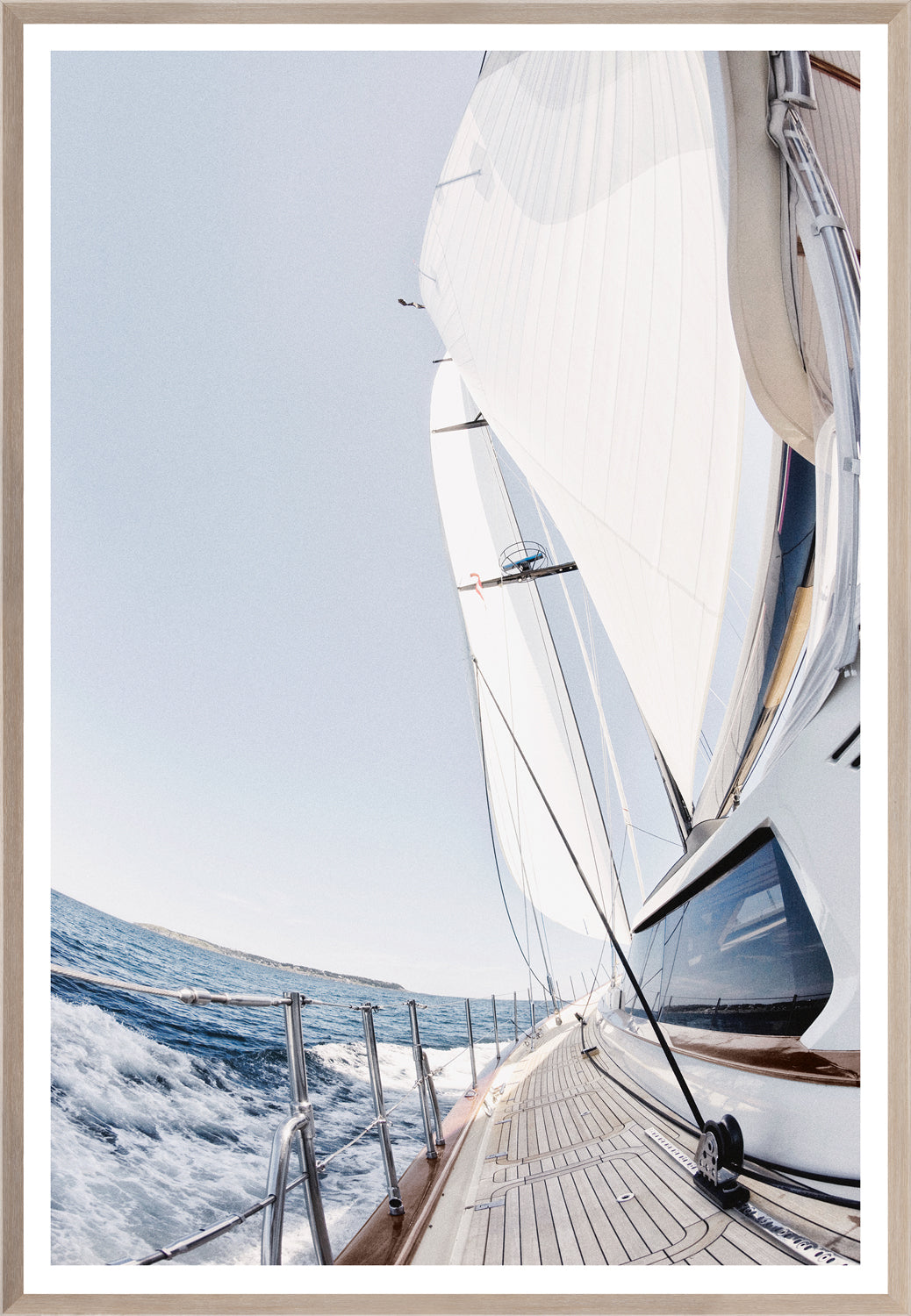 Port Side wall art featuring a sailboat on the ocean with white sails and blue water.