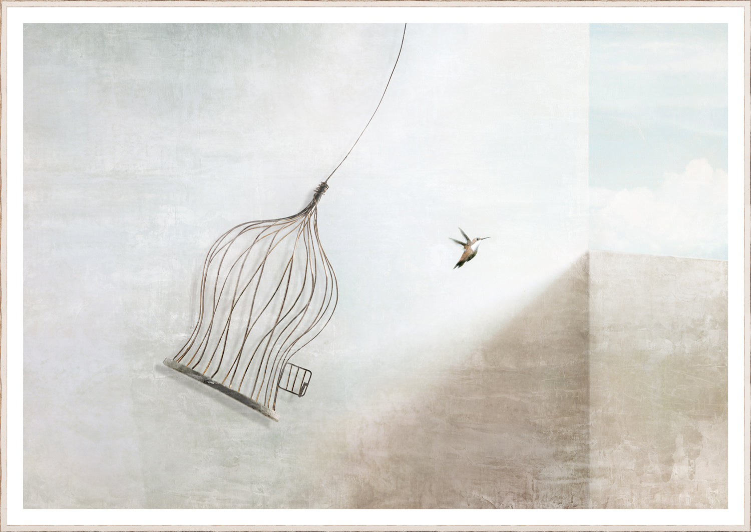 Fly Away wall art featuring a wire birdcage and a hummingbird against a soft blue background.