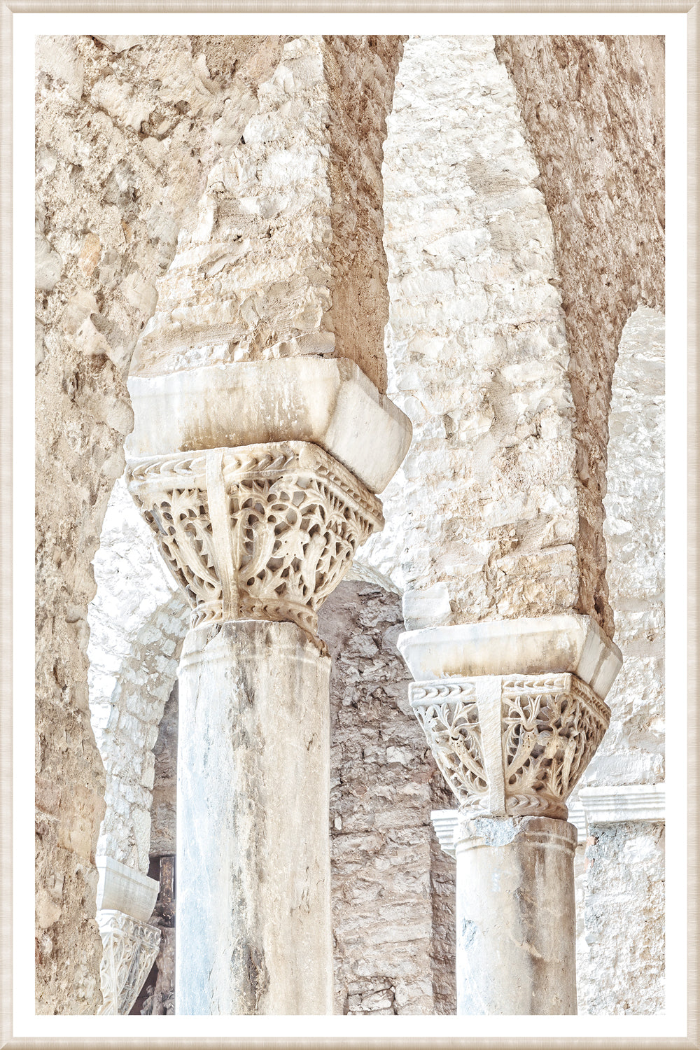 Masonry wall art featuring intricately carved stone columns in Porec, Croatia.