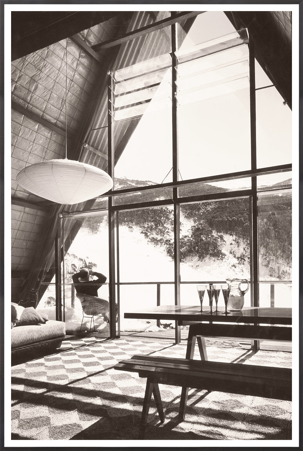 Ski Lodge Interior C. 1966 wall art featuring a cozy cabin with large windows and a mountain view.