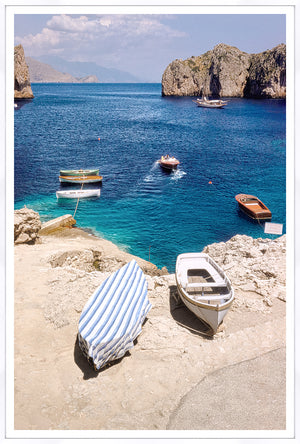 Toni Frissell – Inlet, Capri C. 1959, scenic view of boats in blue water with rocky cliffs