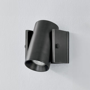 Close-up of the Nowra Wall Sconce in Aged Brass showing the arm curve and shade silhouette.