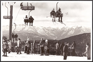 Ski Summit C. 1966 wall art featuring skiers on a chairlift with snowy mountains in the background.