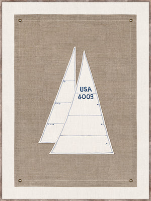 Set Sail IV wall art featuring two sailboat sails in white and blue on a textured beige background.