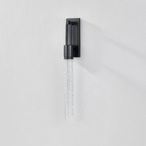 Close-up of the Raynham Wall Sconce in dark bronze showing the arm curve and shade silhouette.