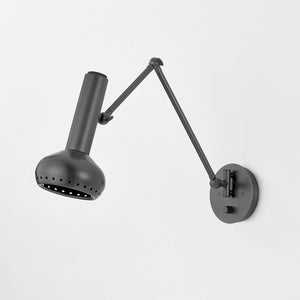 Close-up of the Roald Wall Sconce in dark bronze showing the arm curve and shade silhouette.