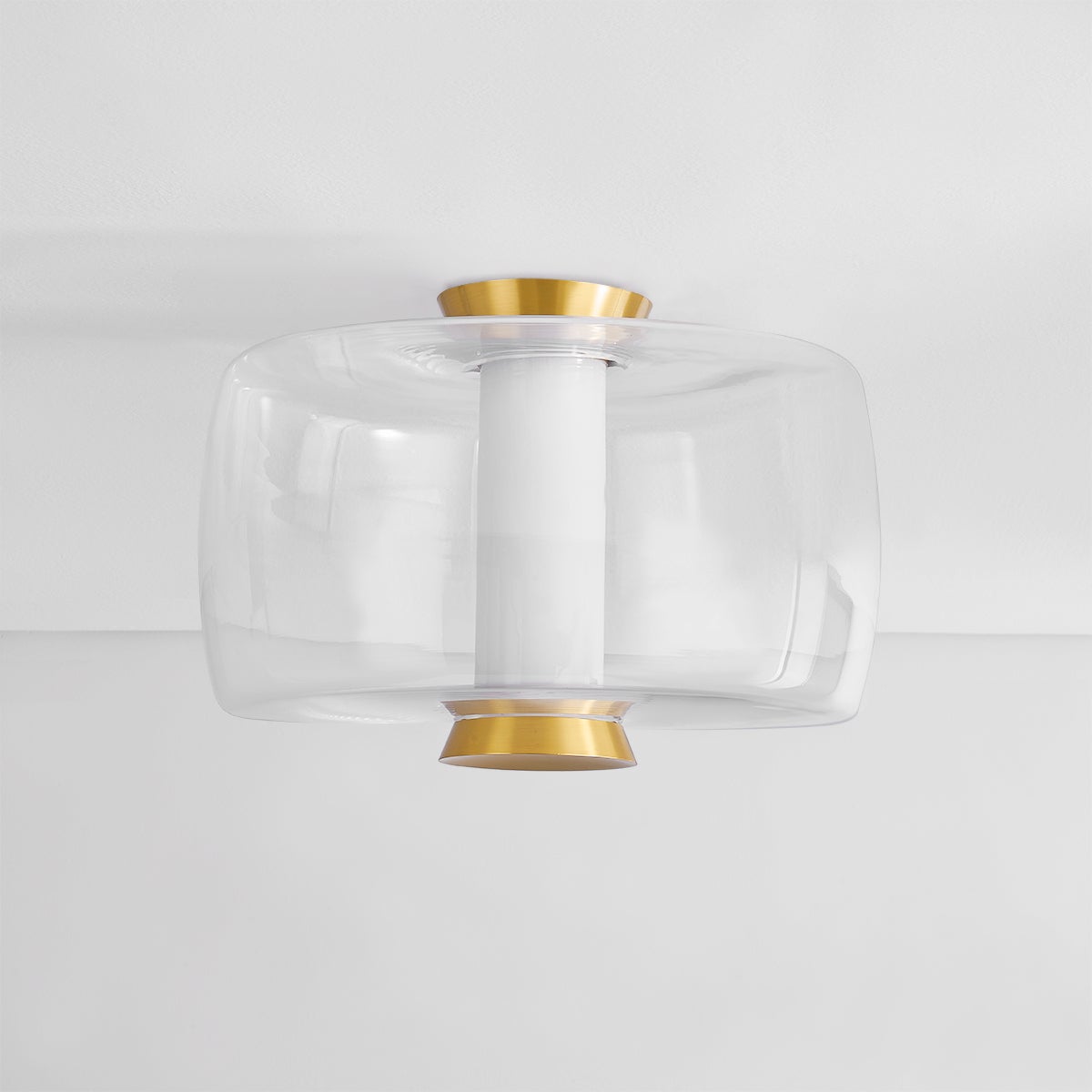 Beau Flush Mount in aged brass shown from the front to reveal the shade profile and mounting canopy.