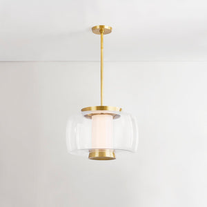 Close-up of the Beau Pendant 20" in aged brass showing the shade shape and metal detail.