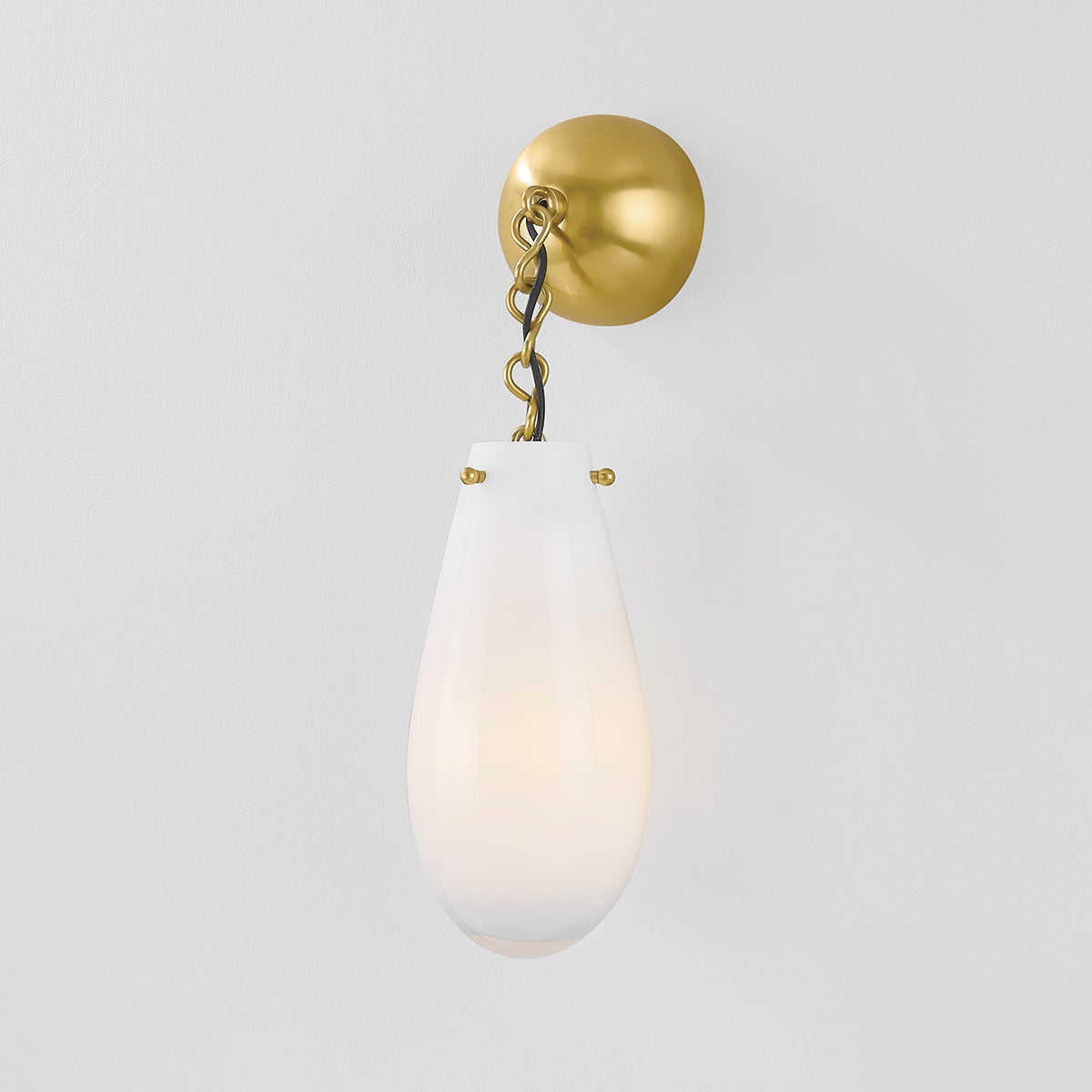Close-up of the Clarkstown Wall Sconce in aged brass showing the arm curve and shade silhouette.