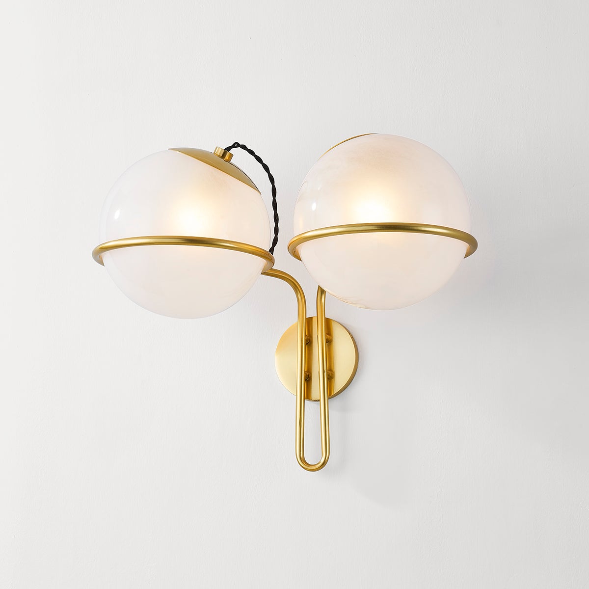 Hingham Wall Sconce in aged brass shown from the front to reveal the arm curve and shade silhouette.