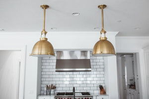 Massena Pendant 19.5" in aged brass shown from the front to reveal the shade shape and metal detail.