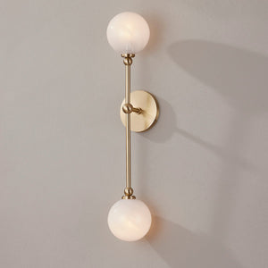 Close-up of the Andrews Wall Sconce in aged brass showing the arm curve and shade silhouette.