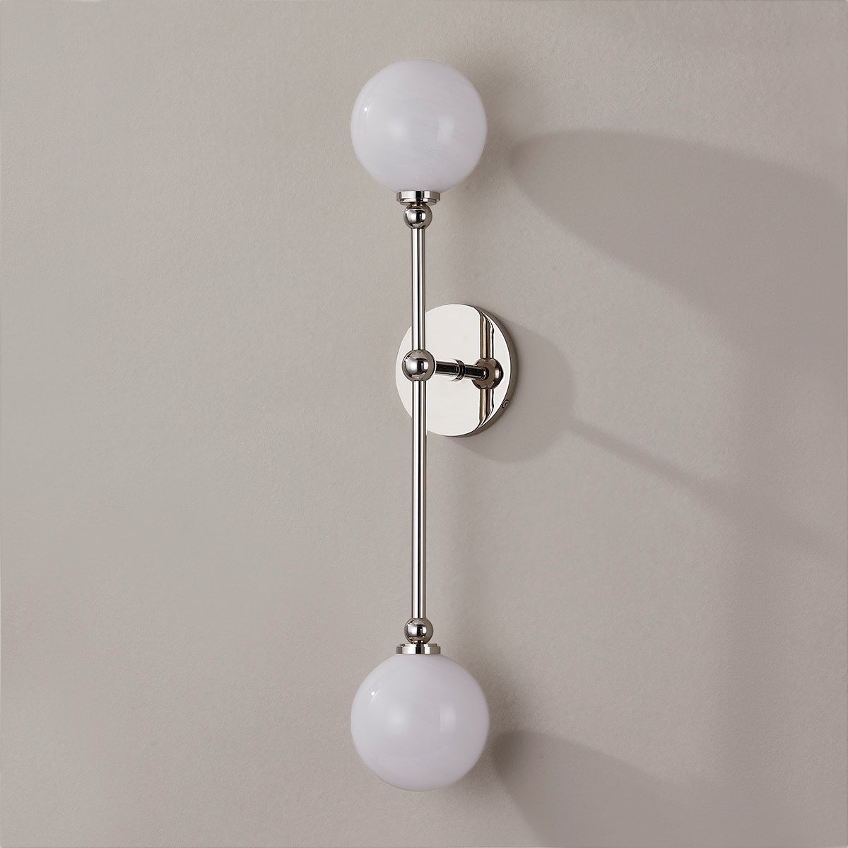 Close-up of the Andrews Wall Sconce in polished nickel showing the arm curve and shade silhouette.