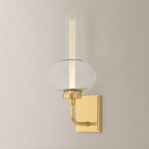 Close-up of the Rossman Wall Sconce in aged brass showing the arm curve and shade silhouette.