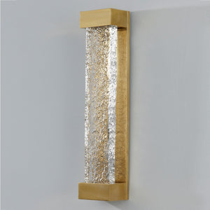 Wharton Wall Sconce 5" x 23" in aged brass shown from the front to reveal the arm curve and shade silhouette.