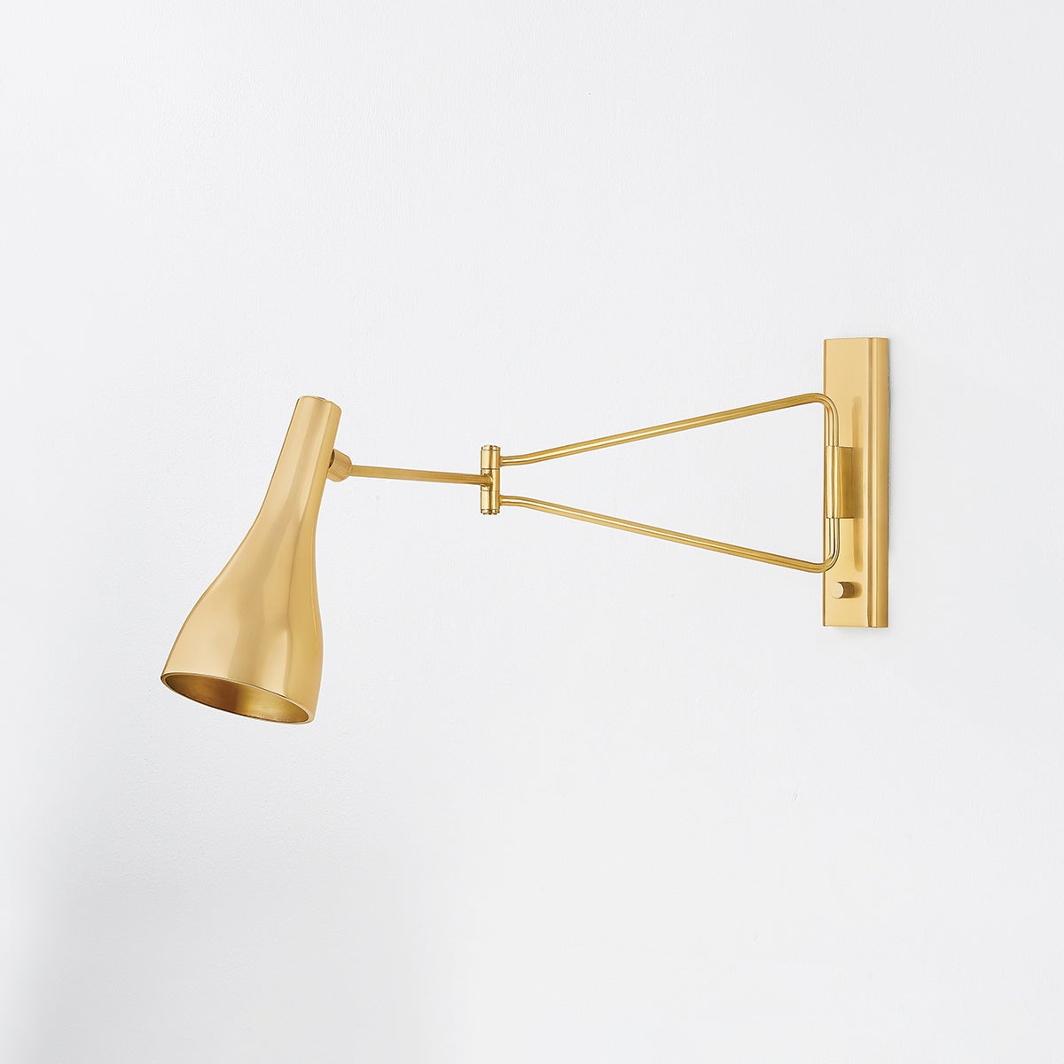 Northford Wall Sconce in aged brass shown from the front to reveal the arm curve and shade silhouette.
