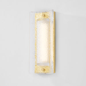 Close-up of the Philmont Wall Sconce in aged brass showing the arm curve and shade silhouette.