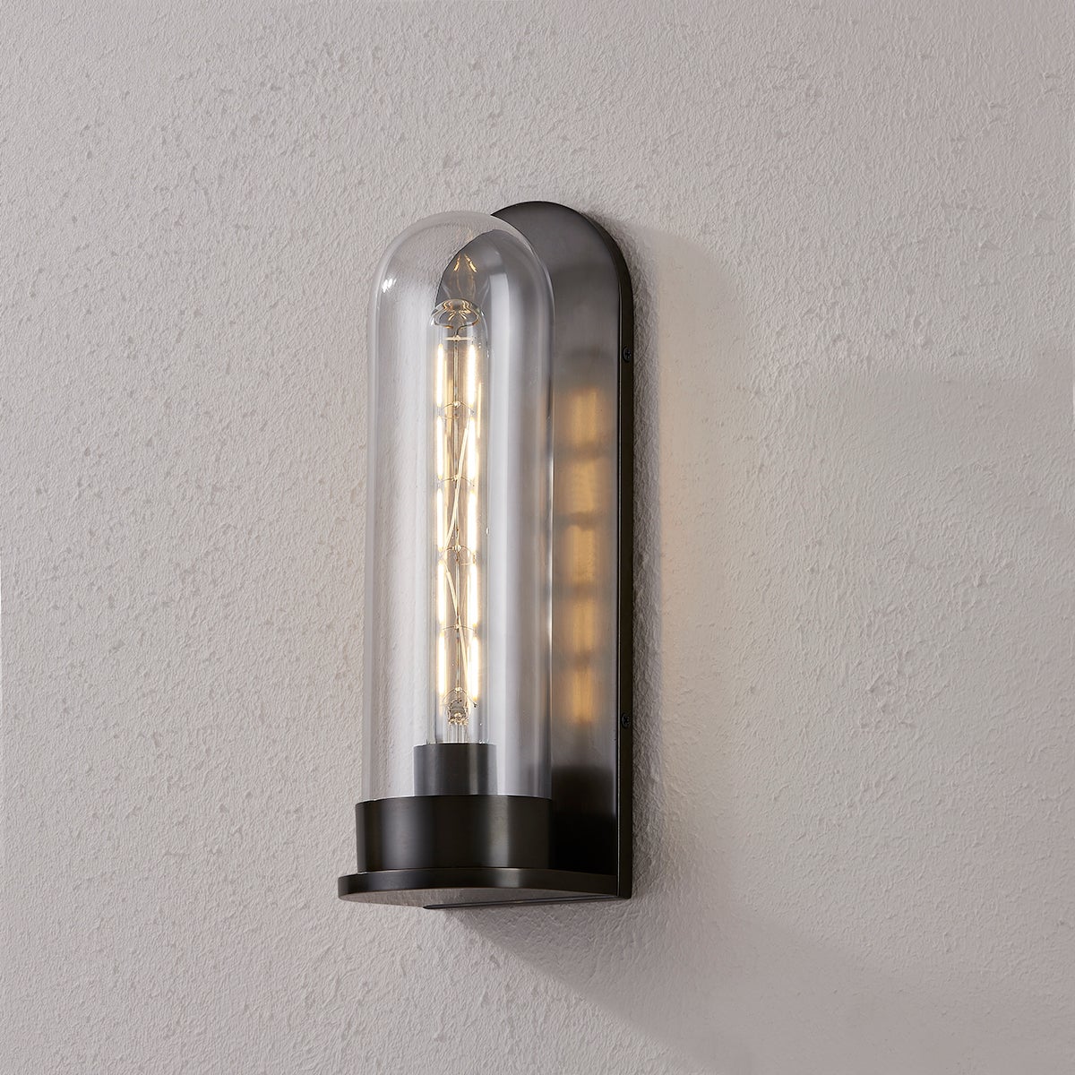 Close-up of the Irwin Wall Sconce in dark bronze showing the arm curve and shade silhouette.