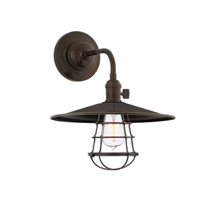 Close-up of the Heirloom Wall Sconce in Aged Brass showing the arm curve and shade silhouette.