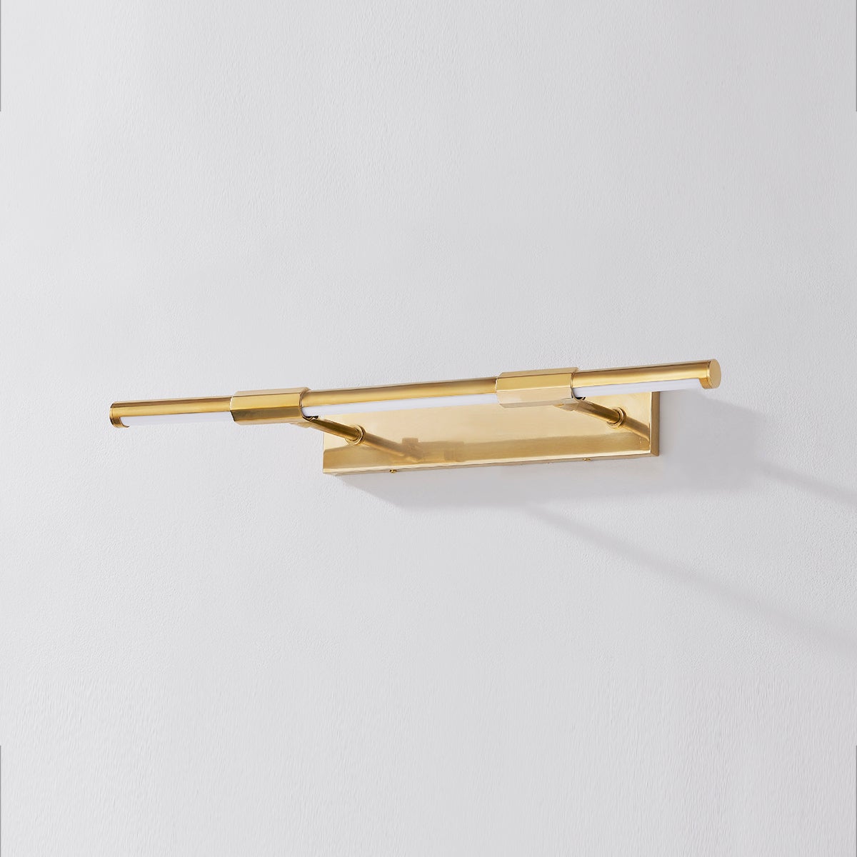 Close-up of the Melbourne Picture Light 23.75" in aged brass showing the arm curve and shade proportion.